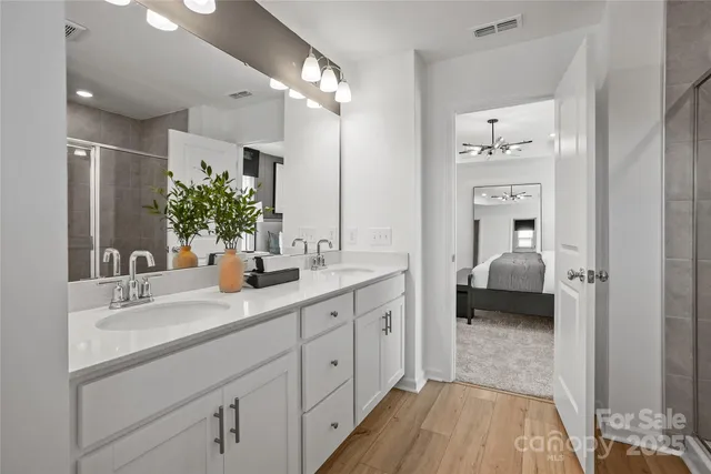 a en suite bathroom with a double sink and mirror