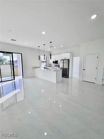a view of a kitchen with a sink and cabinets