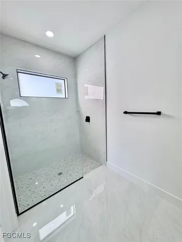 a bathroom with a glass shower door