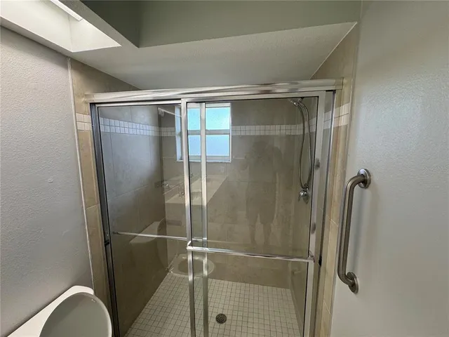 a bathroom with a glass shower door