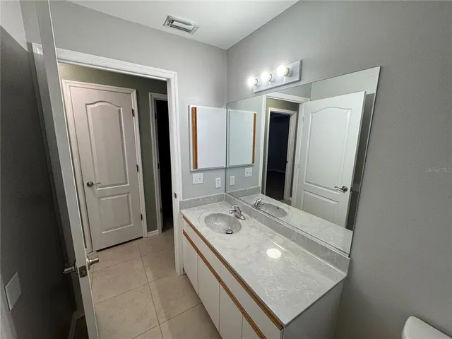 a bathroom with a sink a mirror and a shower
