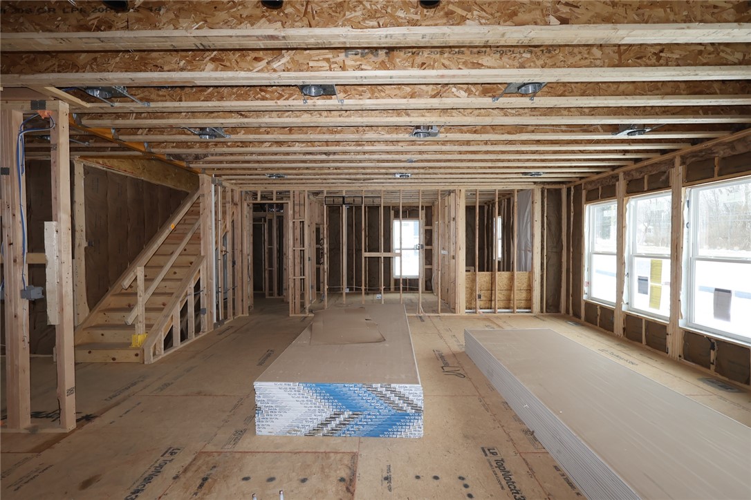 240 Tilly Court, Unit 5 Springboro, OH 45066 - Photo 16 of 26 This interior showcases the foundational structure of a home, revealing exposed wood framing and essential building materials.