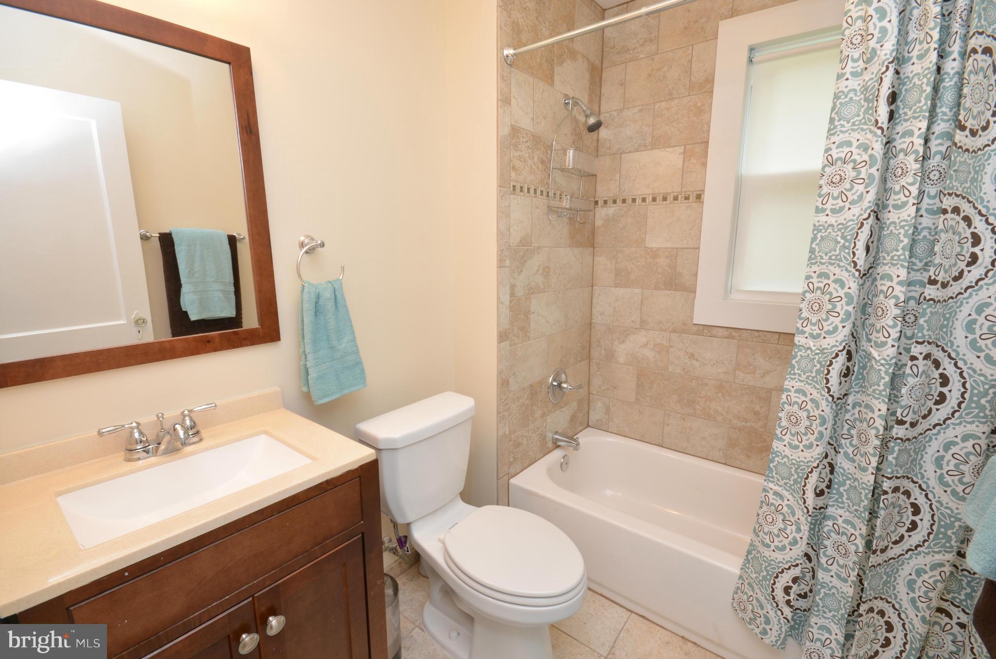 903 Forest Glen Road Silver Spring, MD 20901 - Photo 14 of 30 a bathroom with a sink a toilet and shower