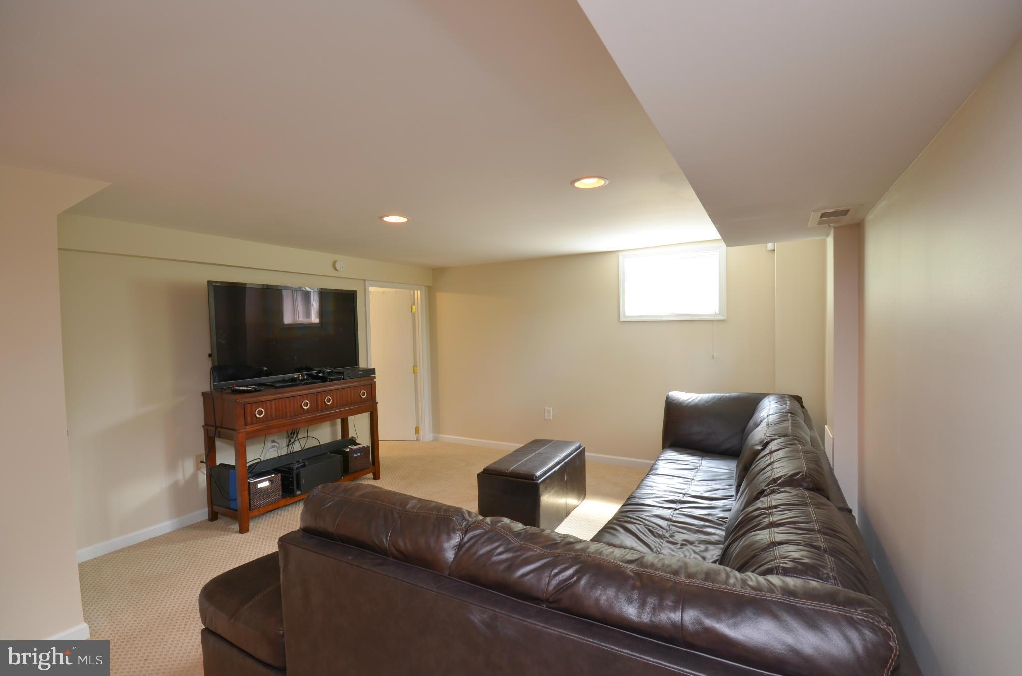 903 Forest Glen Road Silver Spring, MD 20901 - Photo 22 of 30 a living room with furniture and a flat screen tv