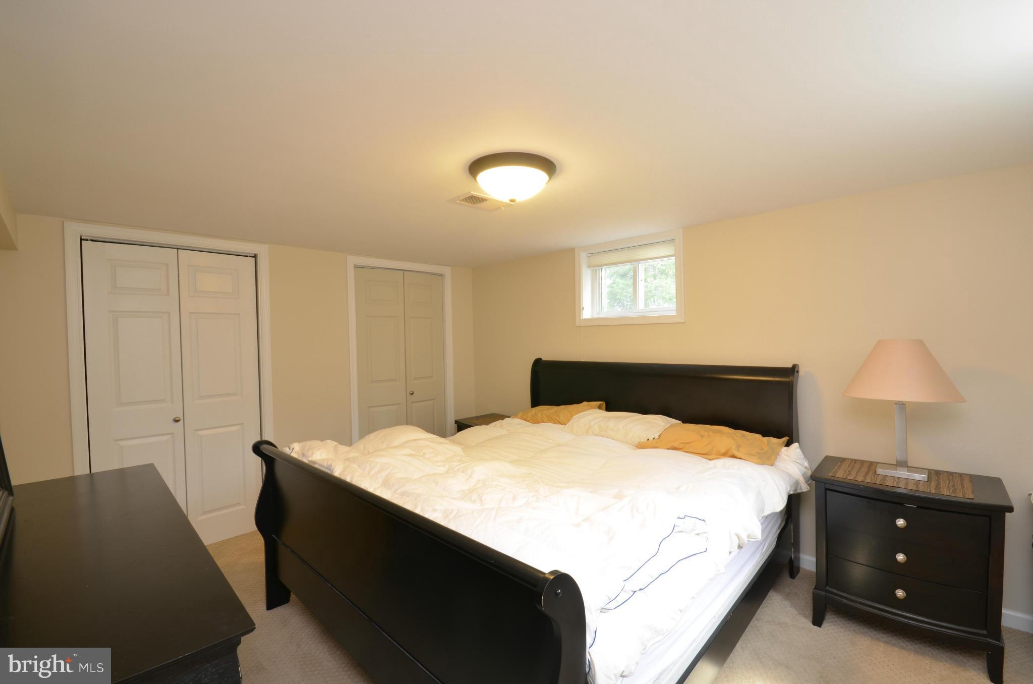 903 Forest Glen Road Silver Spring, MD 20901 - Photo 23 of 30 a bedroom with a bed and a lamp