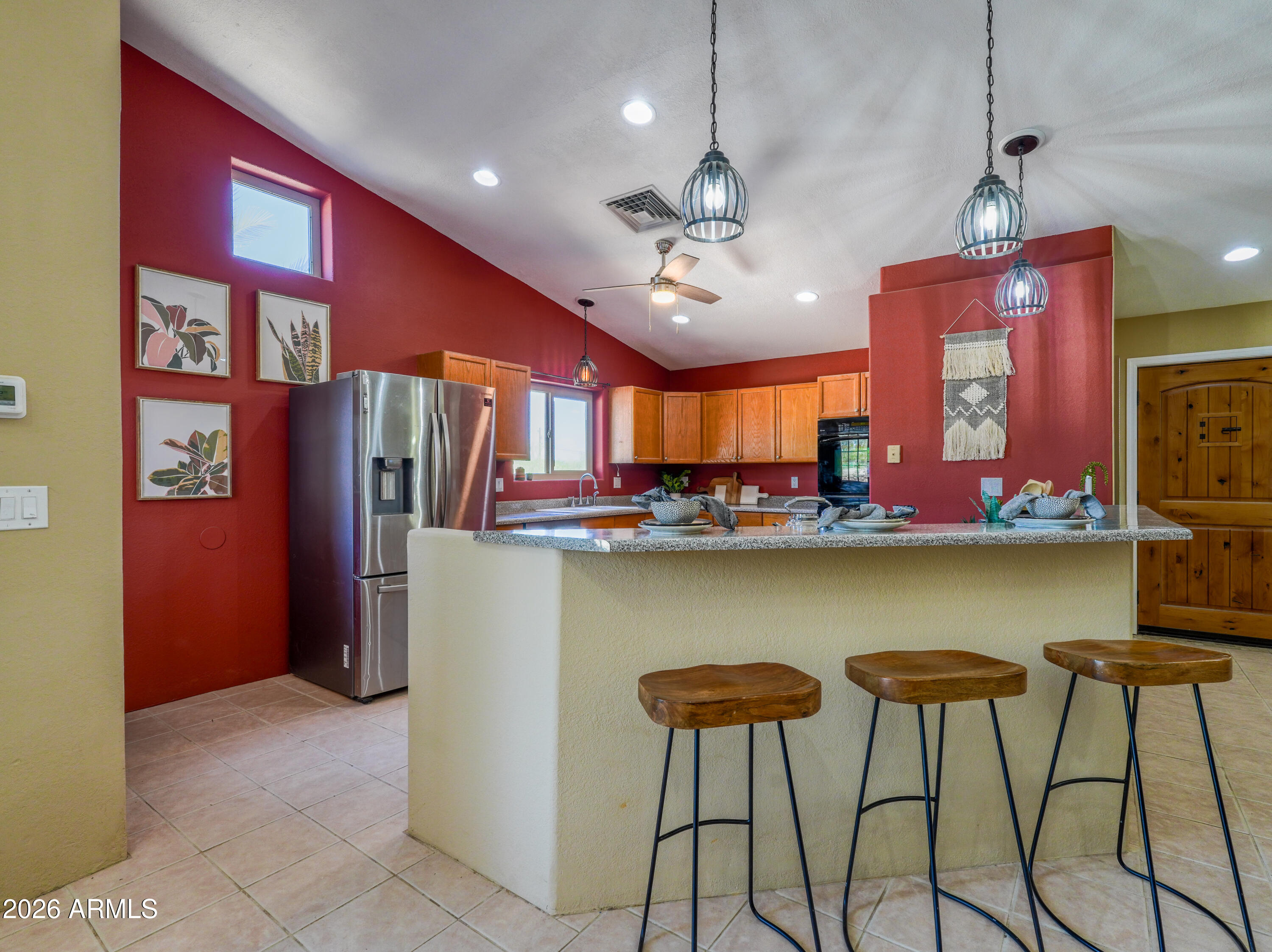 1224 North Acacia Road Apache Junction, AZ 85119 - Photo 4 of 48 a view of a kitchen with stainless steel appliances granite countertop a refrigerator and a counter top space