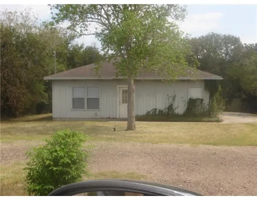 a house with trees in the background