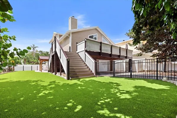 a view of a house with a yard and sitting area