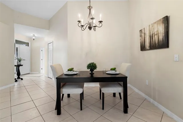 a kitchen with stainless steel appliances granite countertop a refrigerator a sink a stove and white cabinets with wooden floor