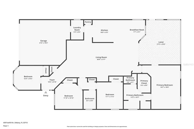 a front view of a house with a yard and large tree