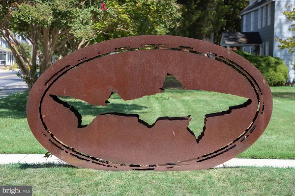 an aerial view of a house with garden space and trees