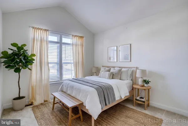 a bedroom with a bed and a potted plant
