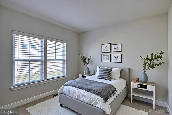 a bedroom with a large bed and a potted plant