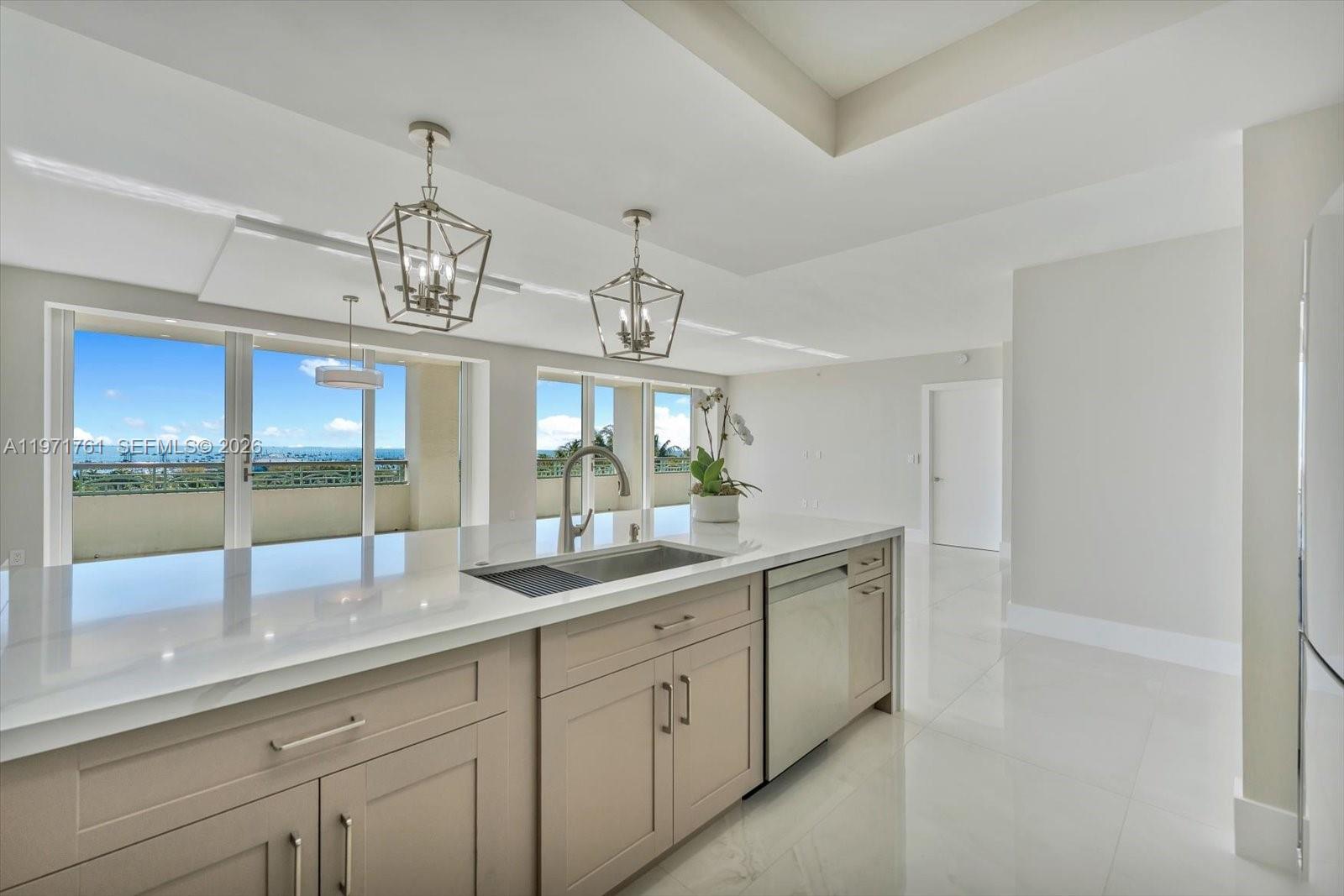 3400 Southwest 27th Avenue, Unit 602 Miami, FL 33133 - Photo 13 of 42 a view of a double sink and chandelier in a room
