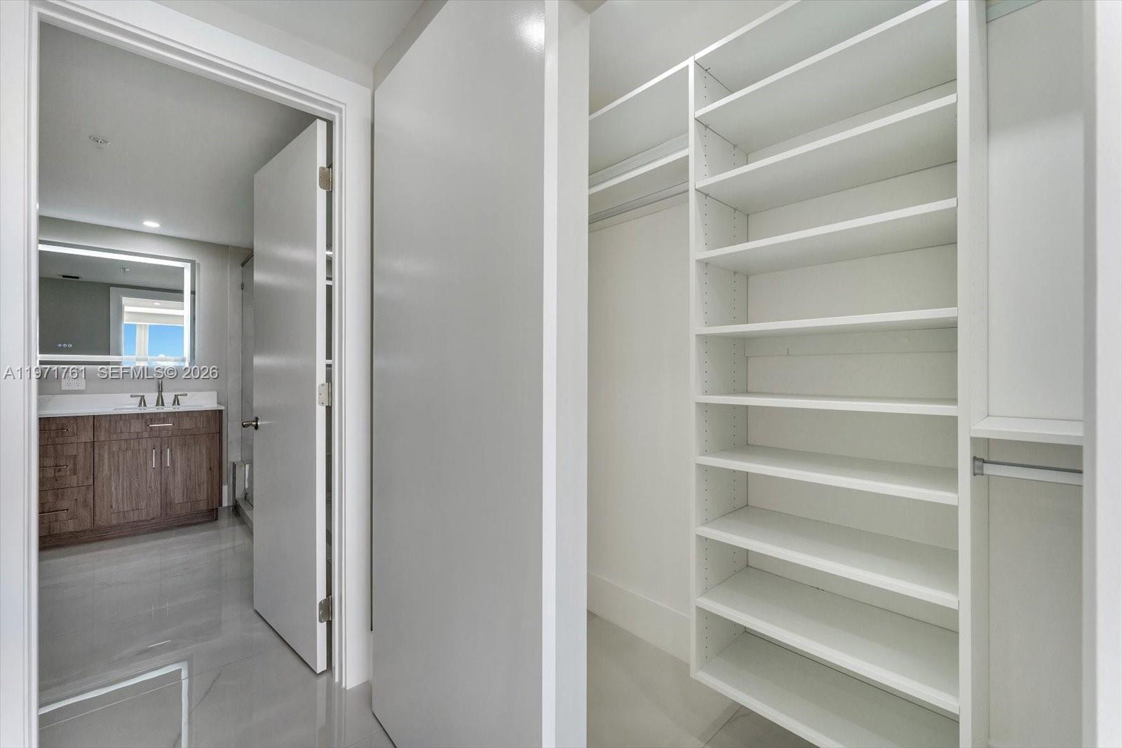 3400 Southwest 27th Avenue, Unit 602 Miami, FL 33133 - Photo 23 of 42 a view of walk in closet and bedroom view