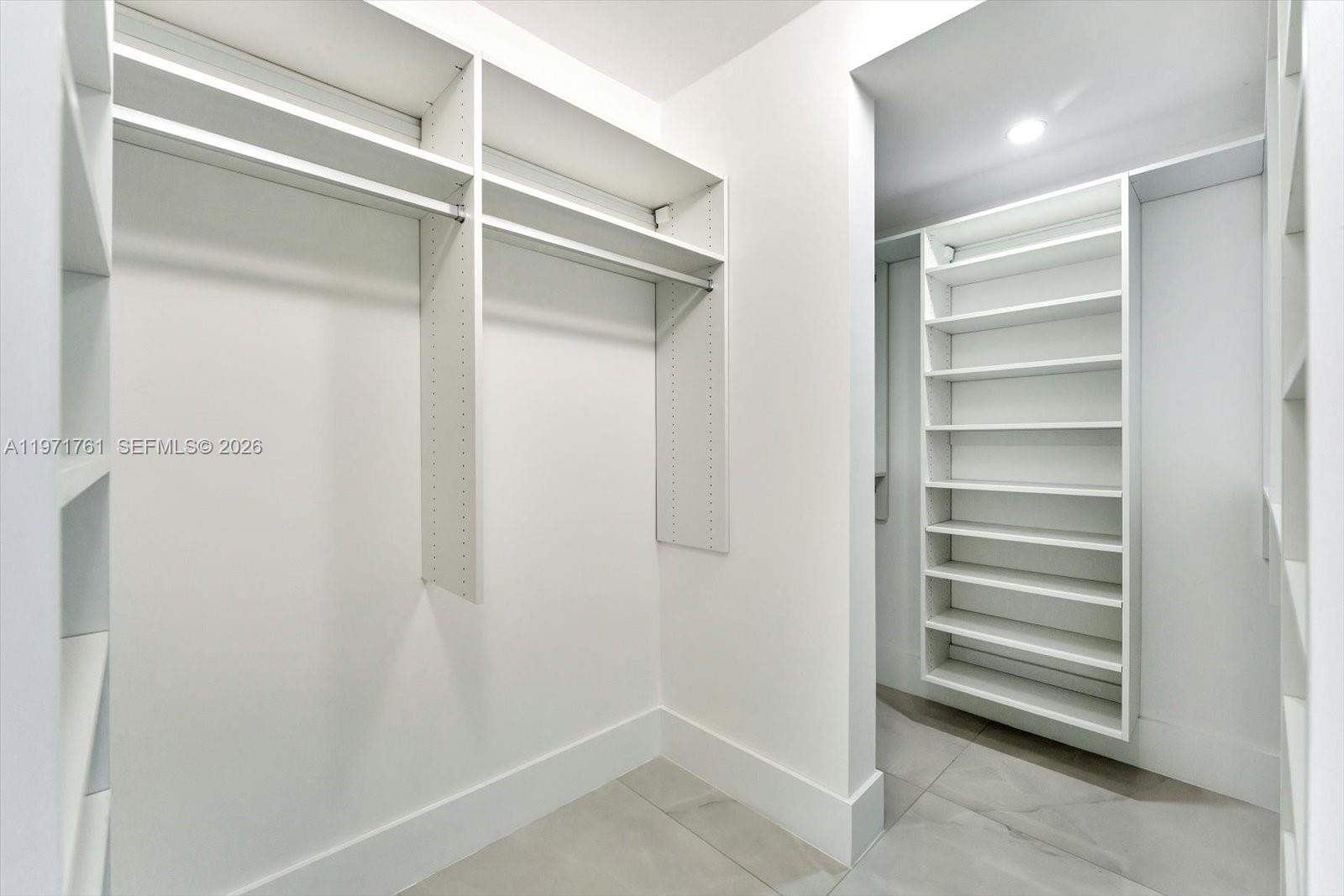 3400 Southwest 27th Avenue, Unit 602 Miami, FL 33133 - Photo 29 of 42 a view of walk in closet with empty racks
