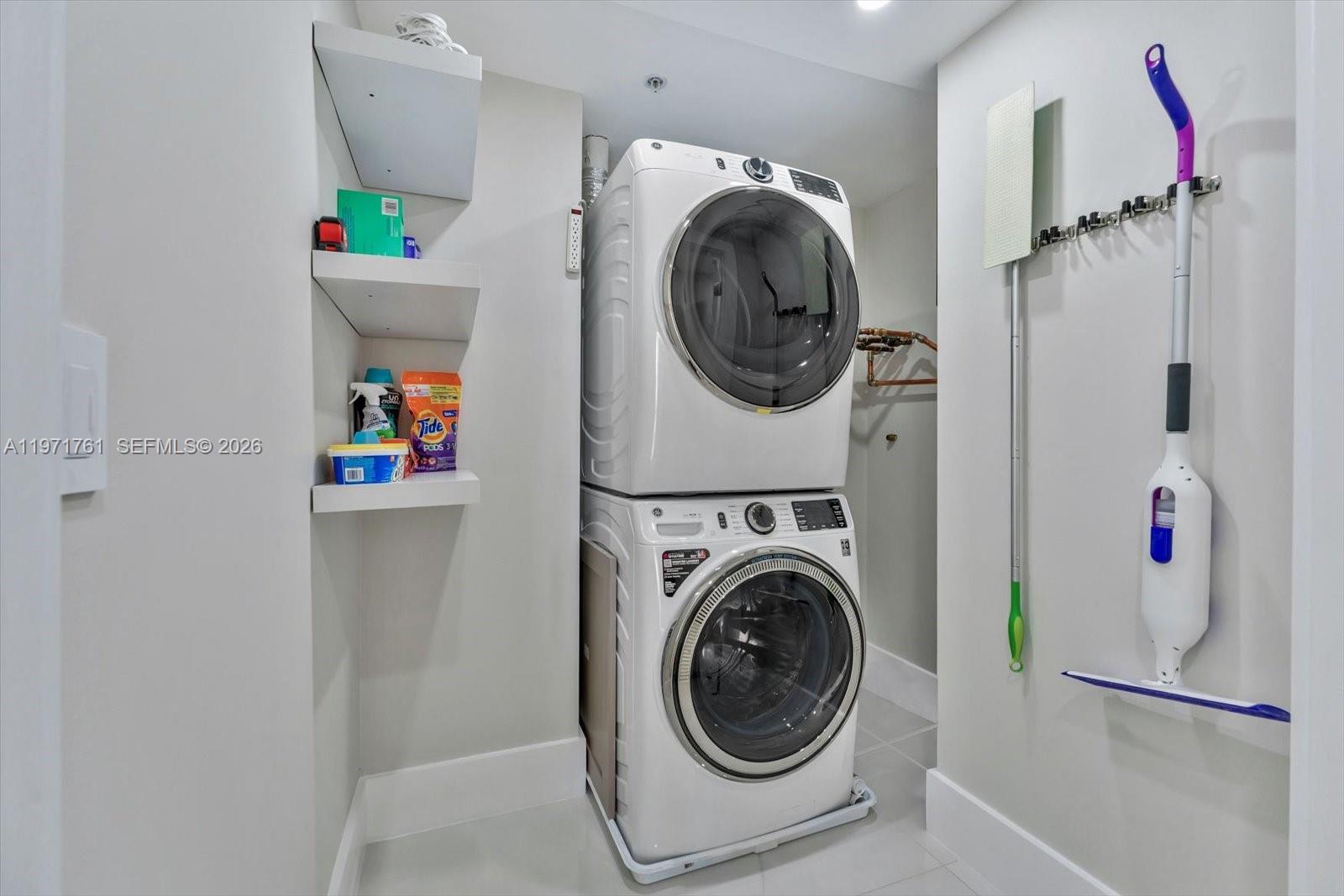 3400 Southwest 27th Avenue, Unit 602 Miami, FL 33133 - Photo 32 of 42 a utility room with dryer and washer