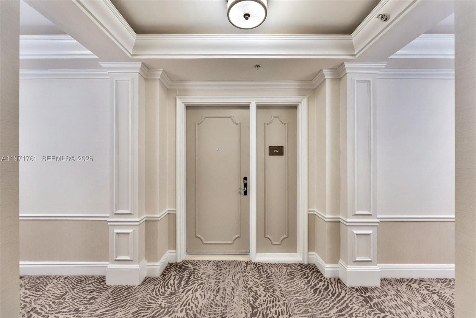 3400 Southwest 27th Avenue, Unit 602 Miami, FL 33133 - Photo 33 of 42 a view of a room with a wooden floor and white walls