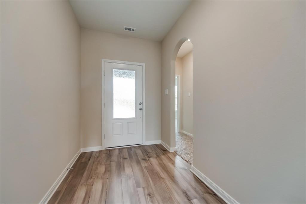 291 Wandering Stream Way Princeton, TX 75407 - Photo 20 of 22 a view of room with window and hardwood floor