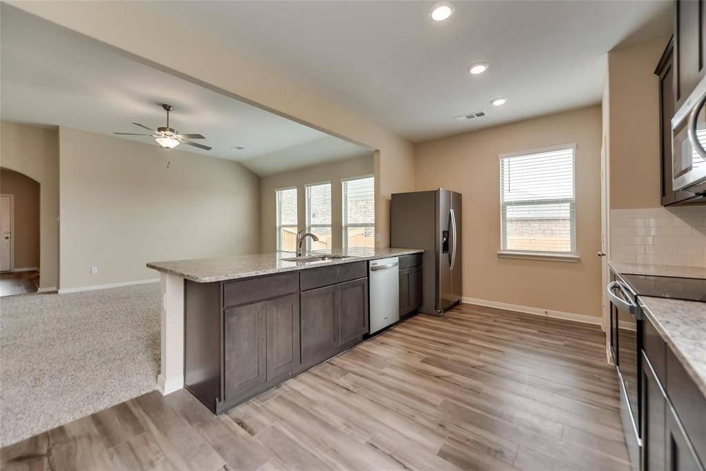 291 Wandering Stream Way Princeton, TX 75407 - Photo 7 of 22 a view of a kitchen with a sink and a window
