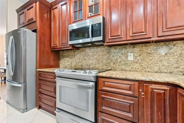 a kitchen with stainless steel appliances granite countertop cabinets and microwave