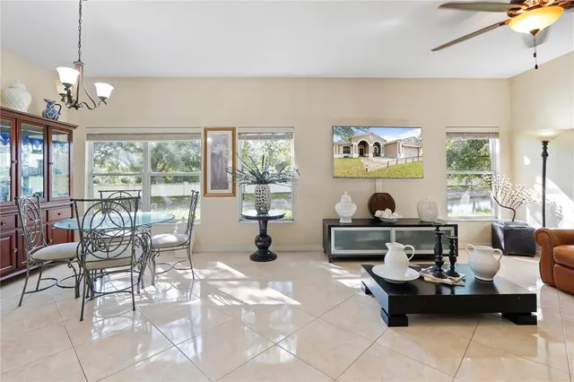 a living room with furniture and large windows