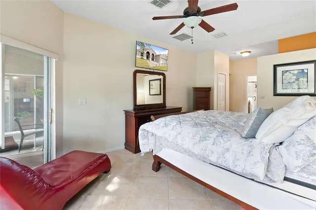 a bedroom with a bed couch and window