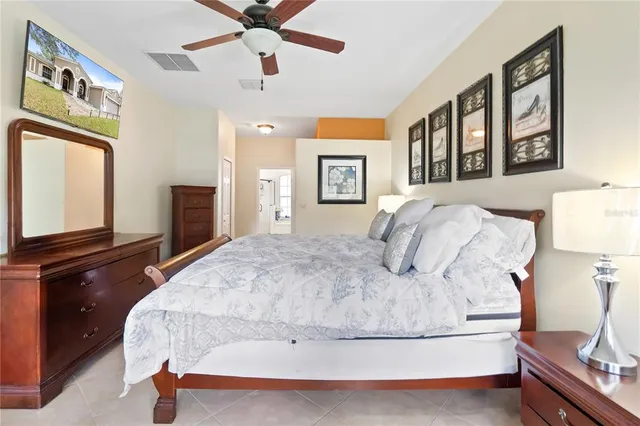 a bed sitting in a bedroom next to a window