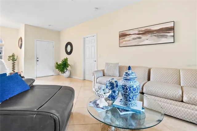 a living room with furniture couches and a dining table