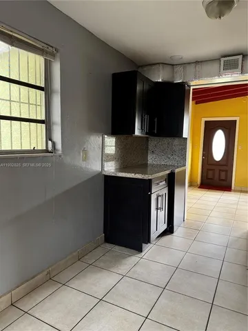 a kitchen with a wooden cabinets and a stove top oven