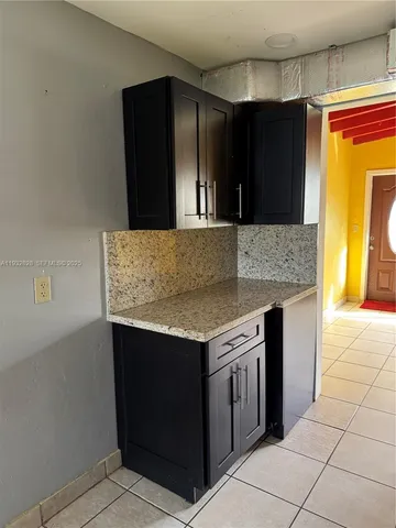 a kitchen with stainless steel appliances granite countertop a stove and a refrigerator