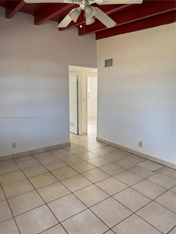 a view of an empty room and a window