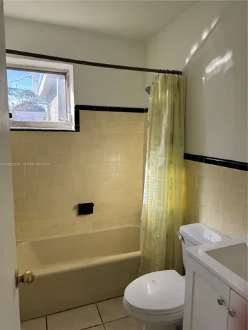 a bathroom with a shower a toilet and a sink