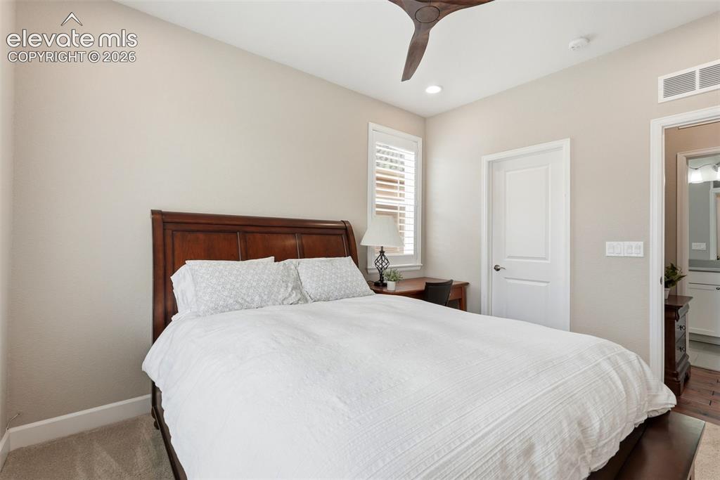 1394 Promontory Bluff View Colorado Springs, CO 80921 - Photo 23 of 47 a large bed sitting in a bedroom and a chandelier