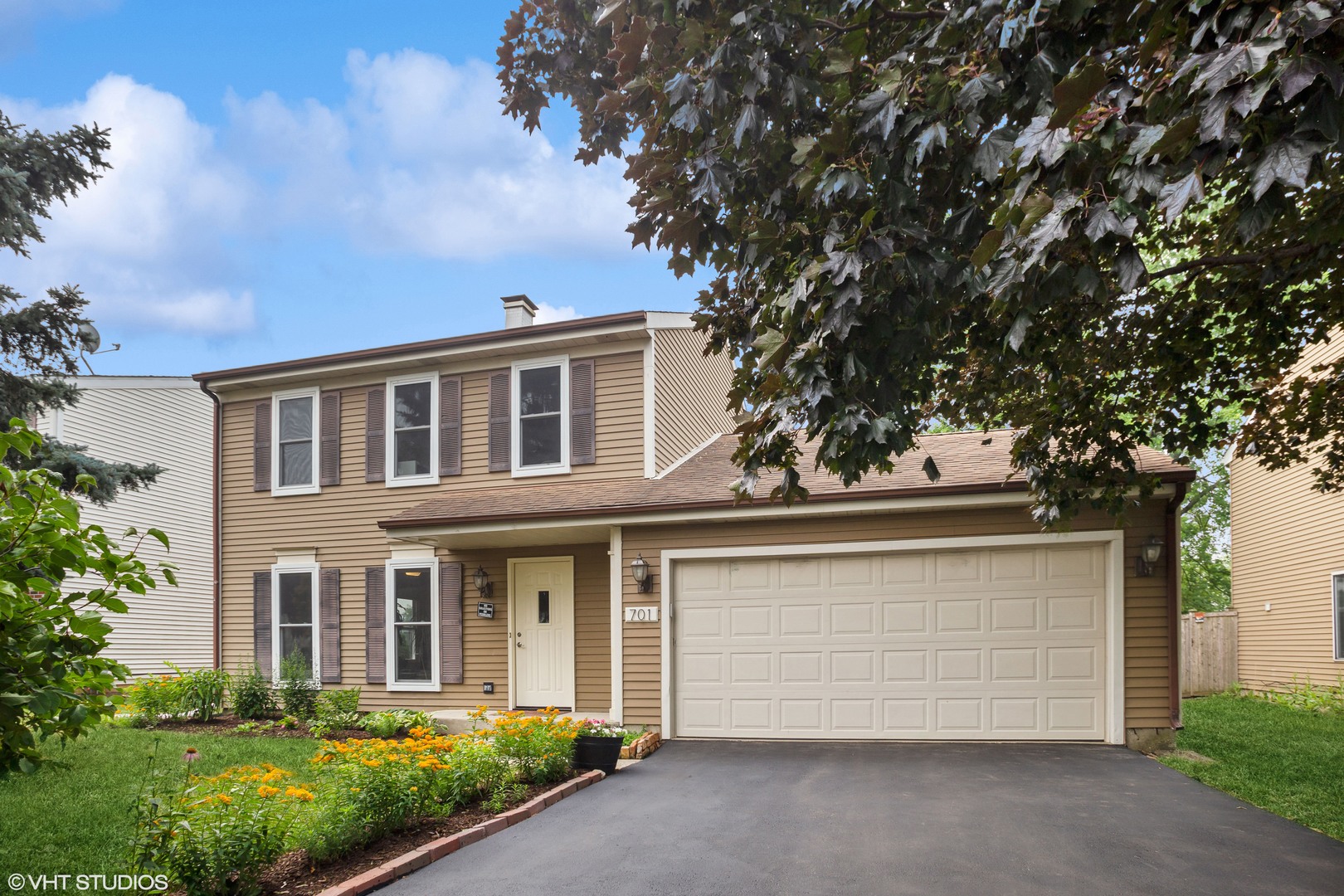 701 Pinebrook Drive Lombard, IL 60148 - Photo 1 of 1 a front view of a house with a garden