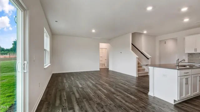 a view of a kitchen with wooden floor and electronic appliances