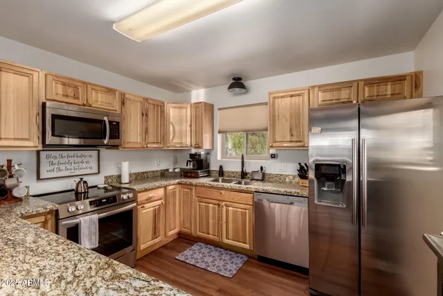 a kitchen with a sink stainless steel appliances and cabinets