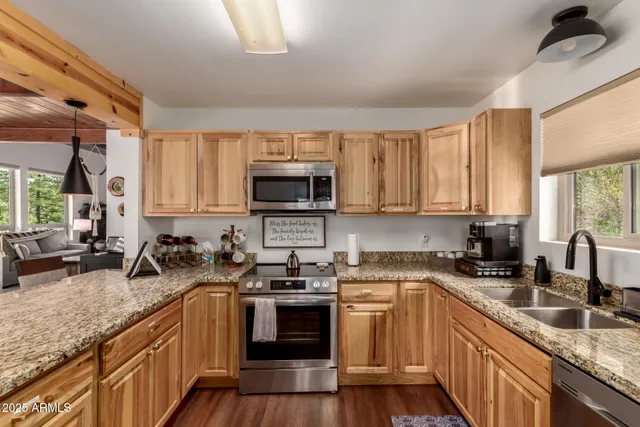 a kitchen with sink a microwave and cabinets