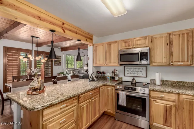 a kitchen with sink a stove and microwave
