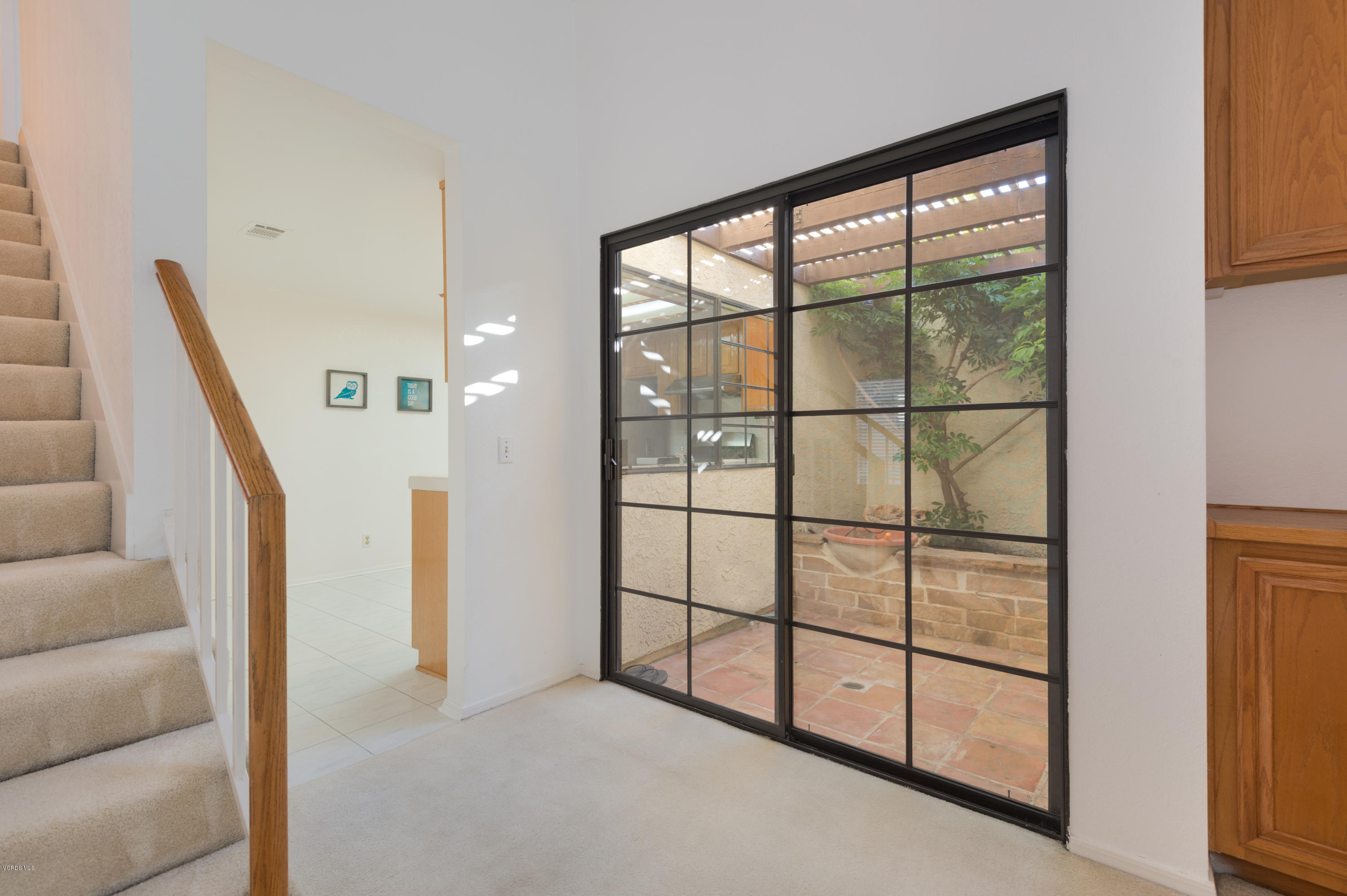 737 Congressional Road Simi Valley, CA 93065 - Photo 5 of 18 a view of staircase with white walls and floor to ceiling window