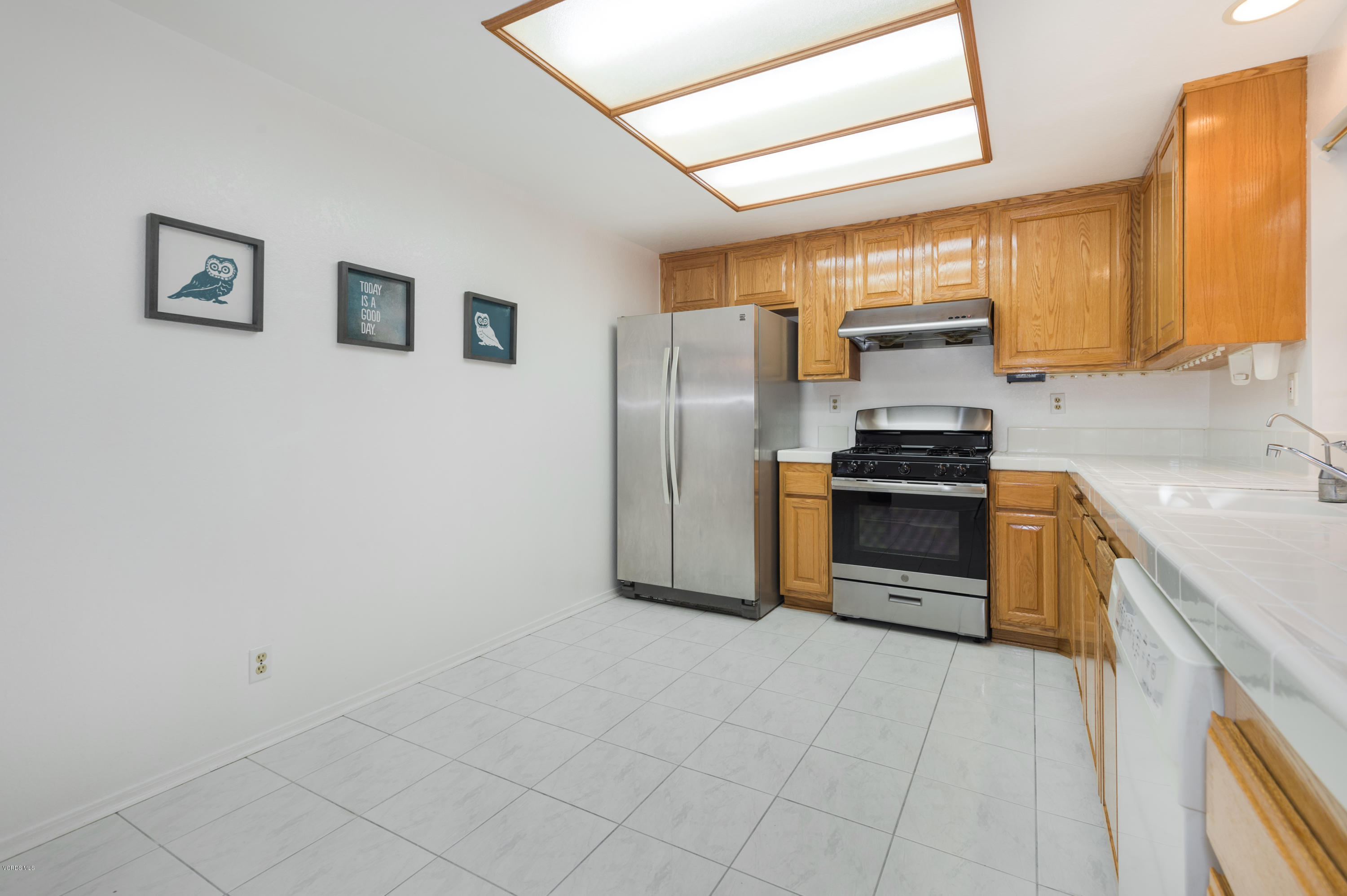 737 Congressional Road Simi Valley, CA 93065 - Photo 7 of 18 a kitchen with stainless steel appliances a refrigerator and a stove top oven