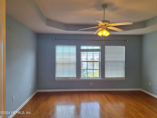 a bathroom with a tub a sink and mirror
