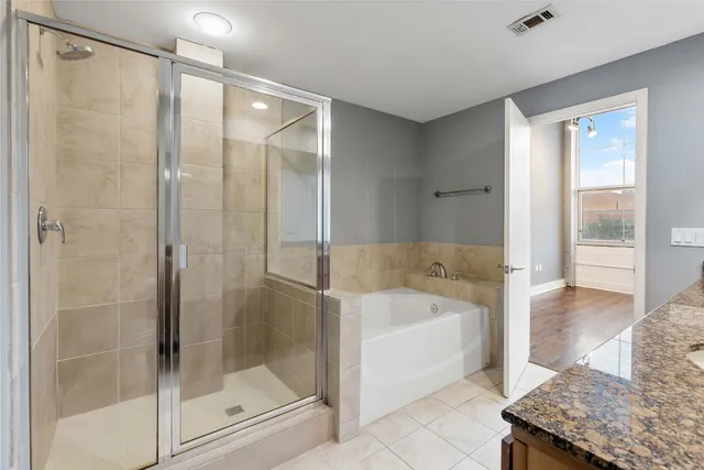 a bathroom with a bathtub and a shower