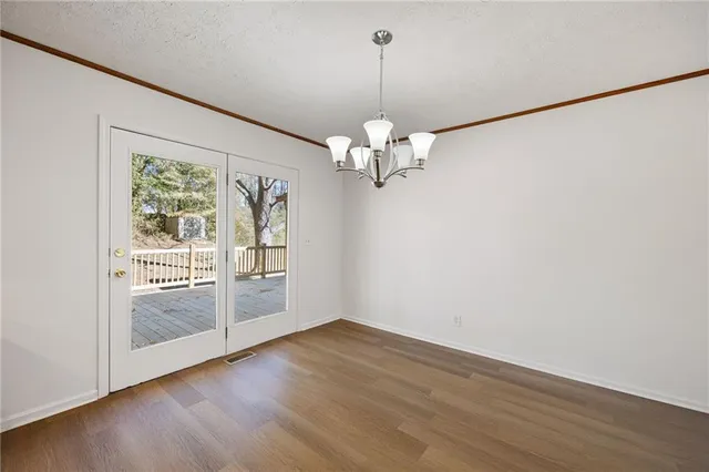 a view of livingroom with window wooden floor and chandelier