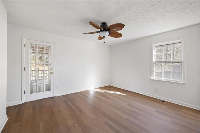 wooden floor in an empty room with a window