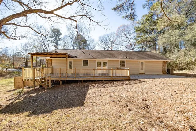 a front view of a house with a yard covered with snow in the background