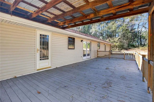 a view of a house with wooden deck