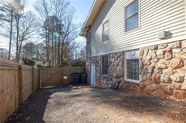 a view of a house with a yard and tree s