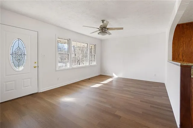 wooden floor in an empty room with a window