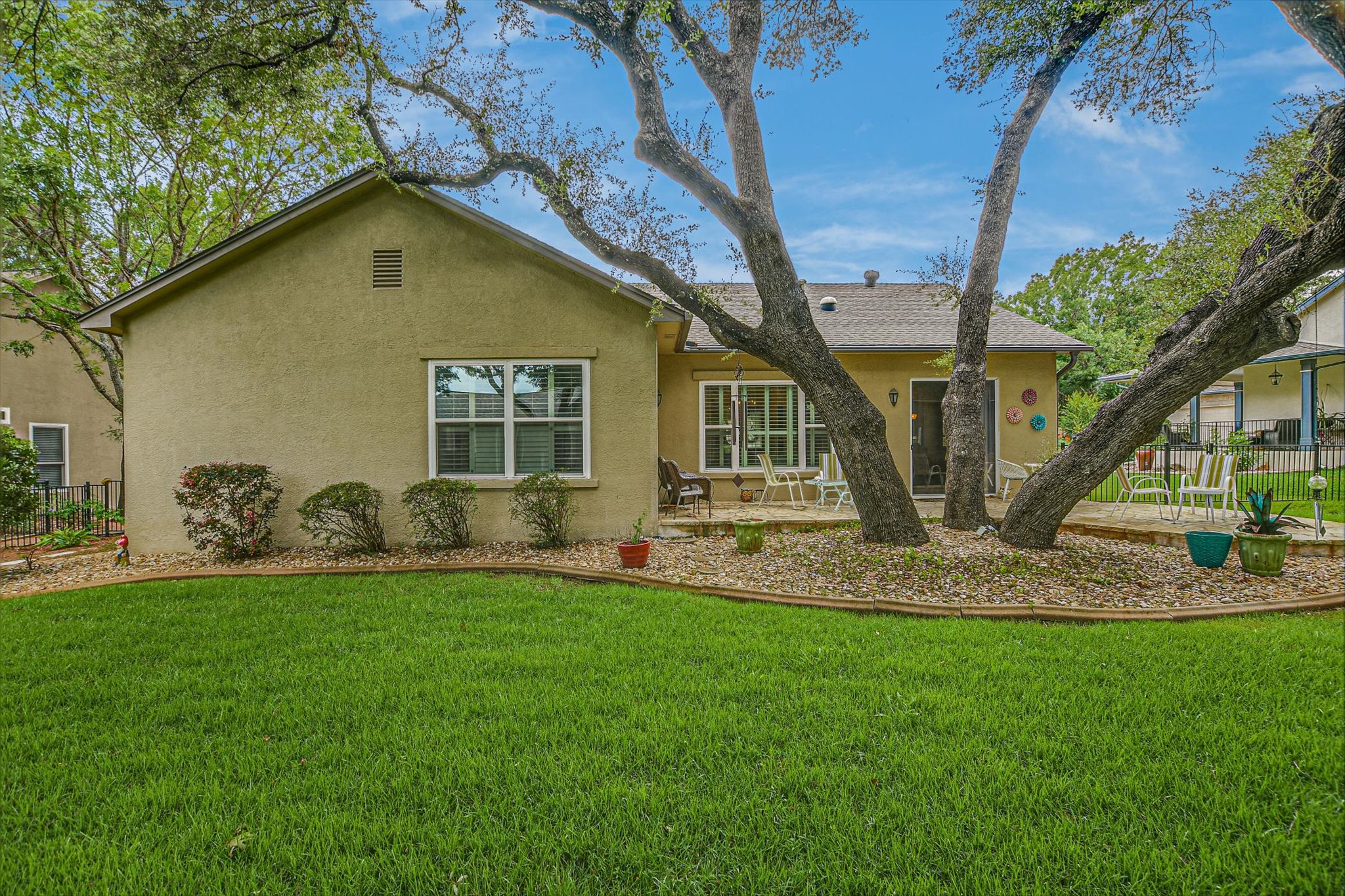 106 Nighthawk Way Georgetown, TX 78633 - Photo 27 of 29 Mature trees shade a private yard with a compact patio perfect for outdoor enjoyment.
